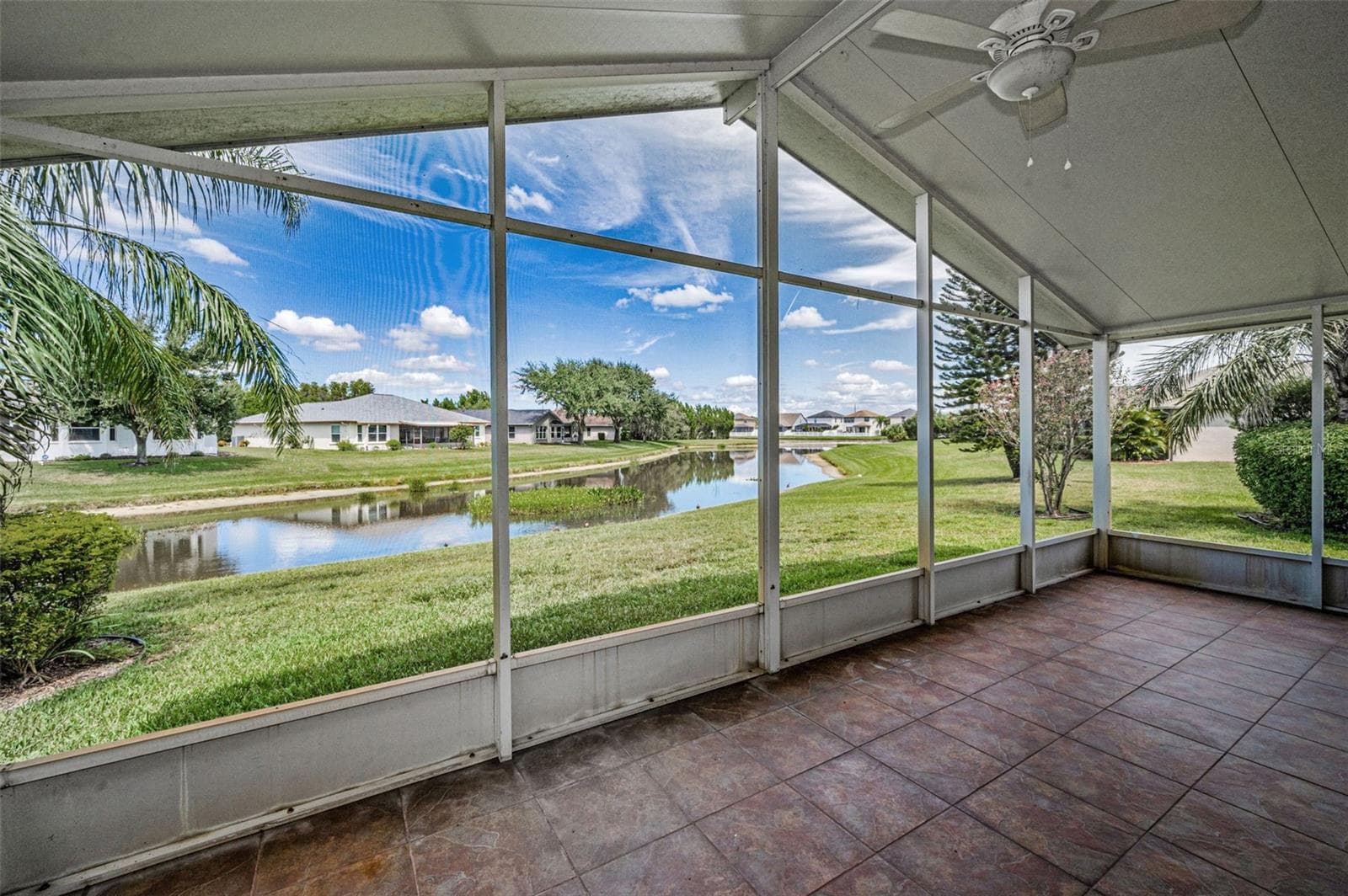 VIEW OF LANAI TO THE STUNNING POND PERFECT FOR WATCHING WILDLIFE. - 12021 FERN TERRACE CT, TRINITY