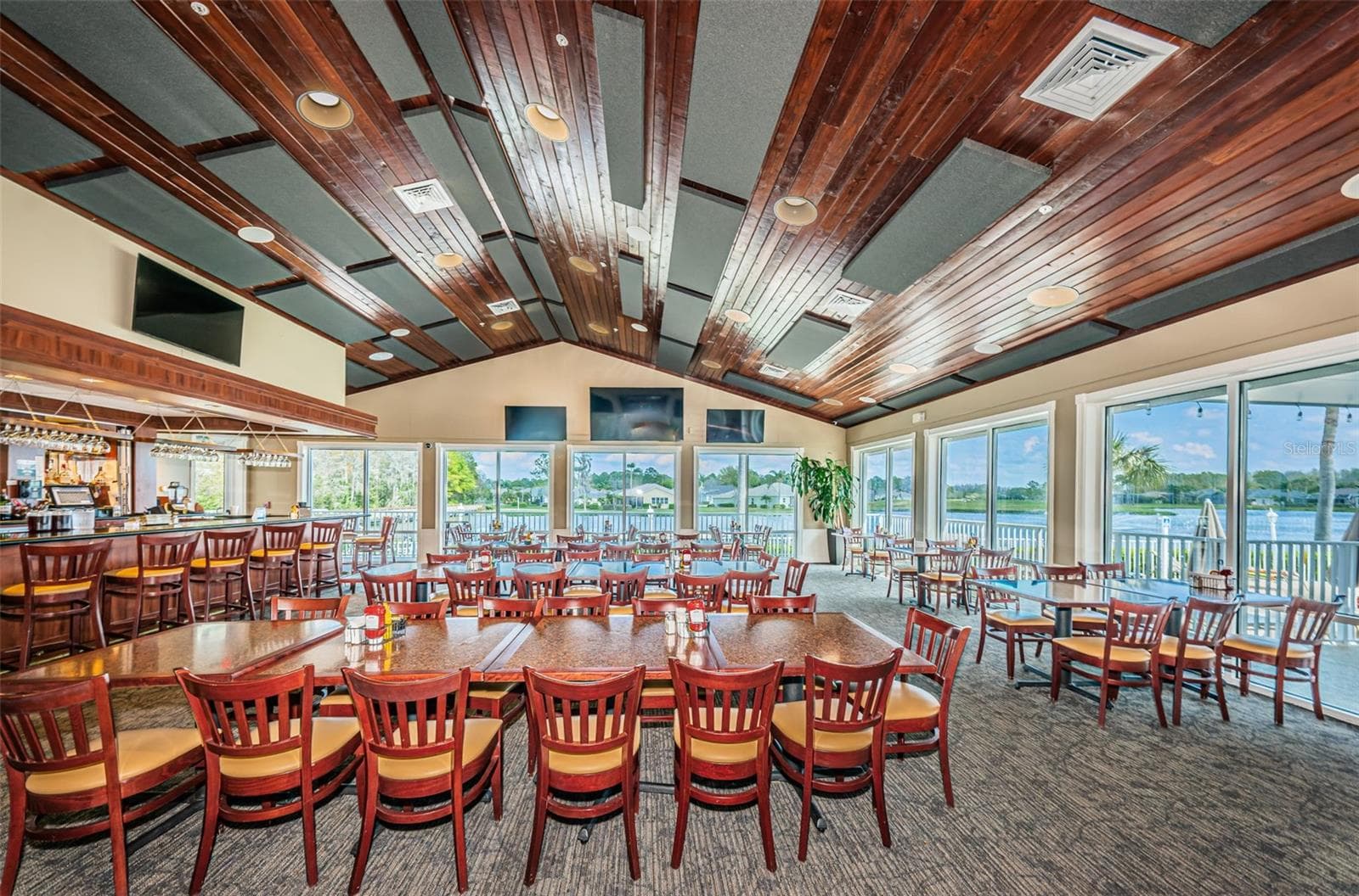 BAR AREA OF THE RESTAURANT WITH VIEWS OF POND AND COMMUNITY POOL. - 12021 FERN TERRACE CT, TRINITY