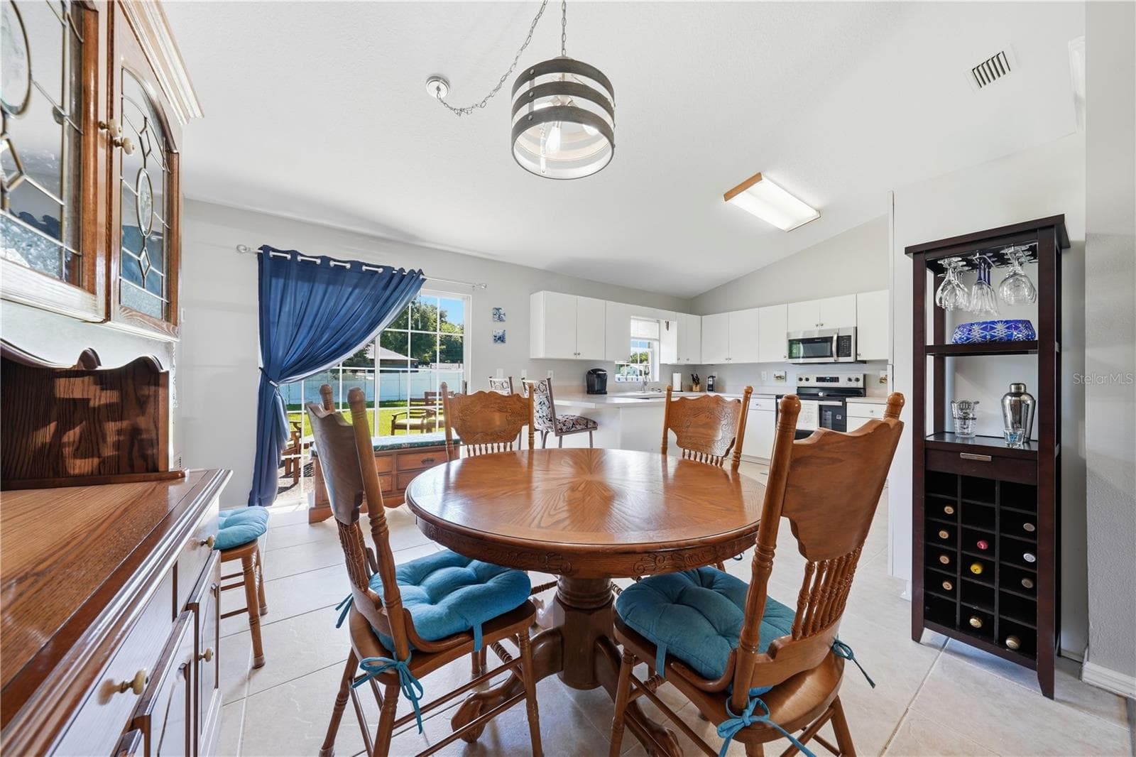 Dining Room with view into the kitchen and backyard - 3835 NE 13TH AVE, OCALA
