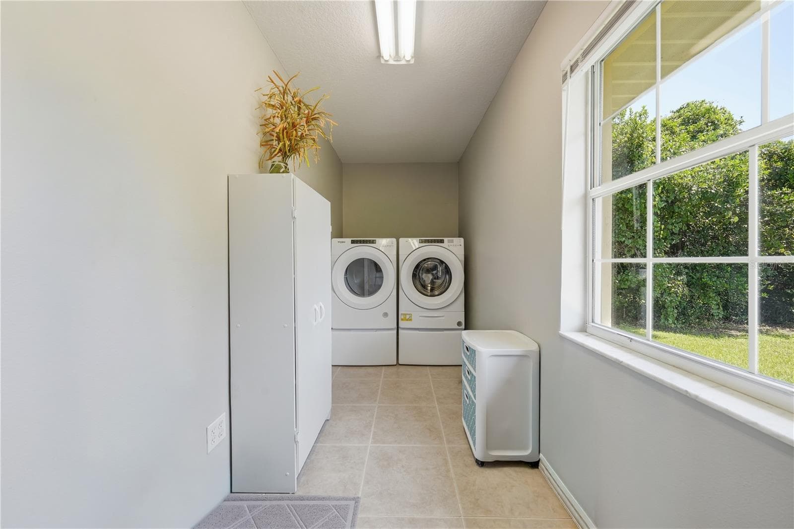 Laundry room with storage closet. Washer, dryer, and storage closet stay with the home. - 3835 NE 13TH AVE, OCALA