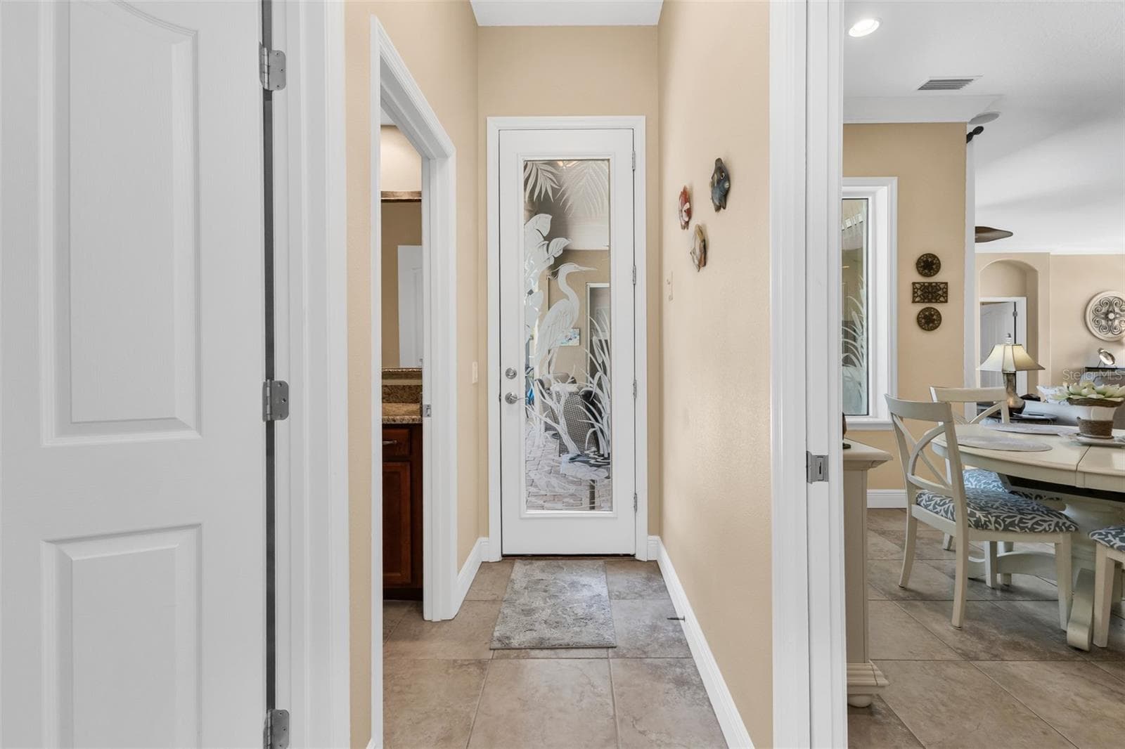 Pocket door leads to guest rooms plus pool access behind the etched glass door - 24228 PEPPERCORN RD, PUNTA GORDA