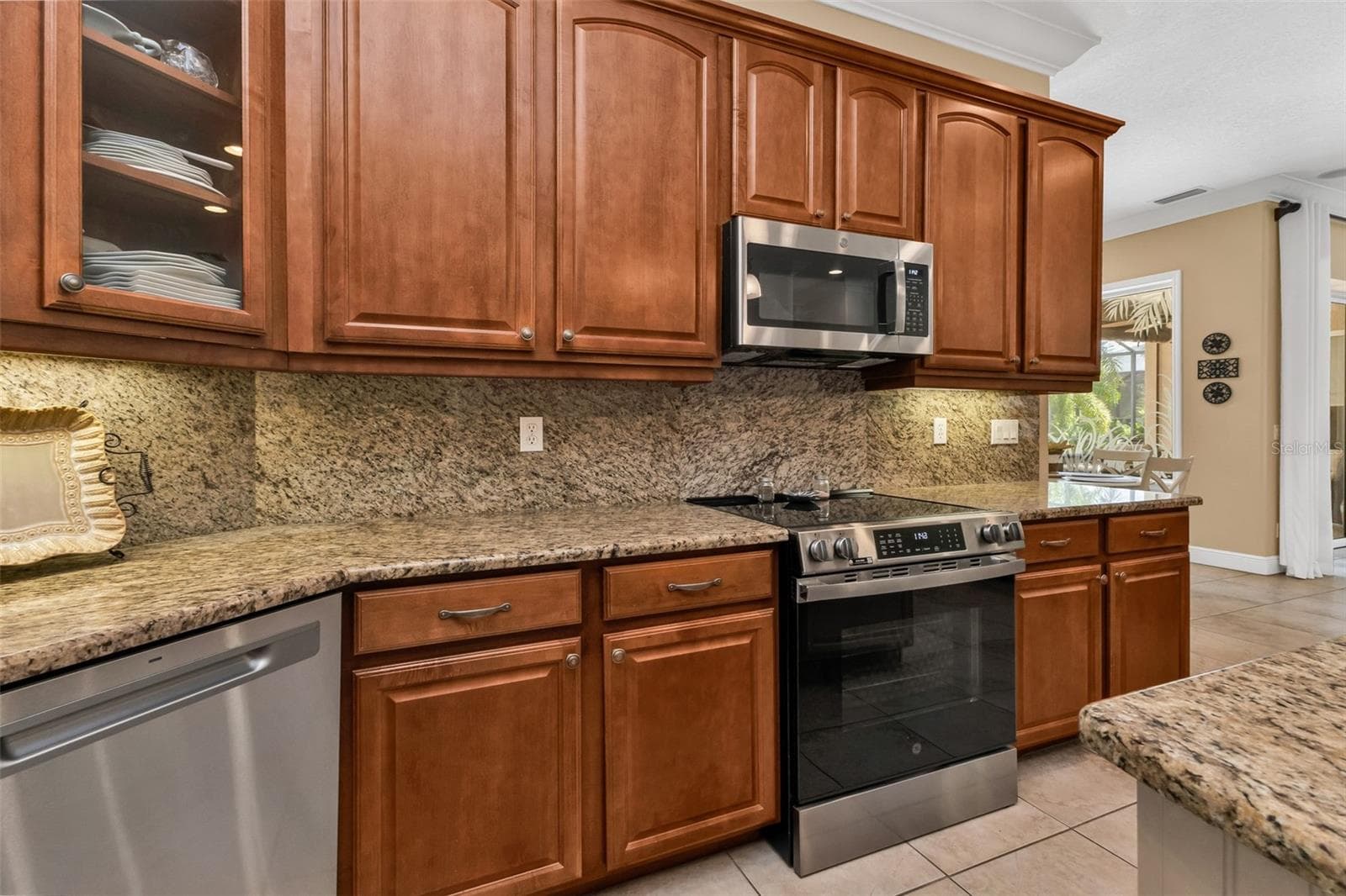 Soft close cabinetry, pull-out drawers on lower cabinets plus glass fronts on some uppers. - 24228 PEPPERCORN RD, PUNTA GORDA