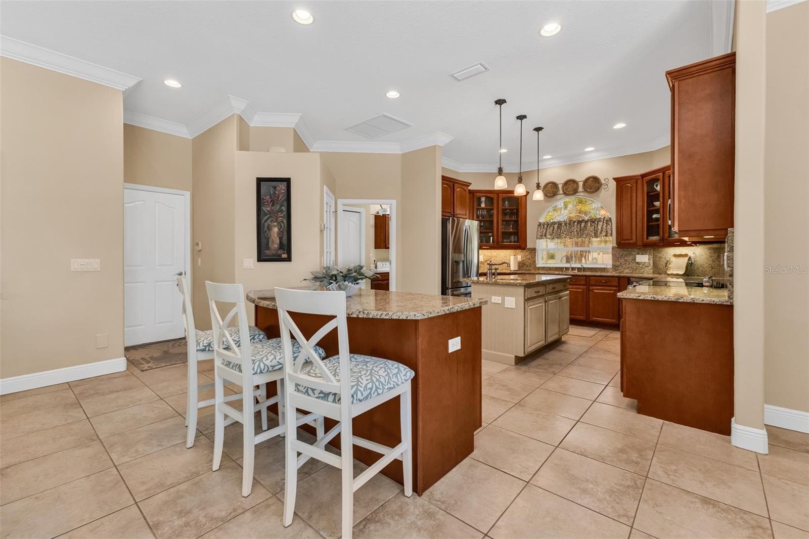 Door to the three-car garage sits off the kitchen and adjacent to the walk-in pantry shown to the right - 24228 PEPPERCORN RD, PUNTA GORDA