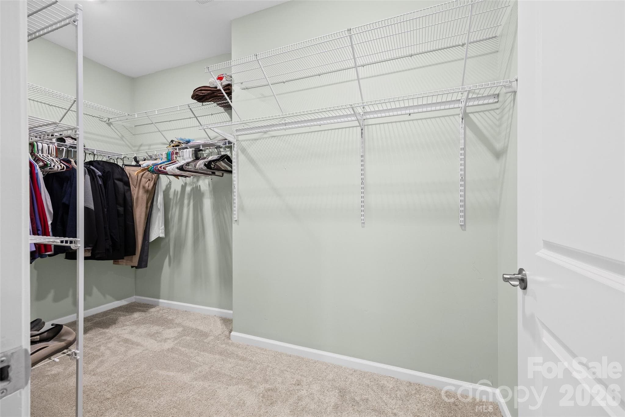 Generously sized primary closet offers plenty of room to organize wardrobes by season, with space for everything in its place. - 596 Rustlewood Way, Rock Hill