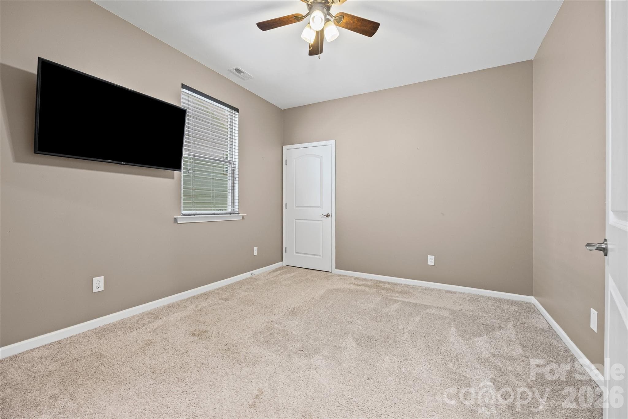 Spacious bedroom with a generous walk-in closet, offering comfort, flexibility, and plenty of storage for any family’s needs. - 596 Rustlewood Way, Rock Hill