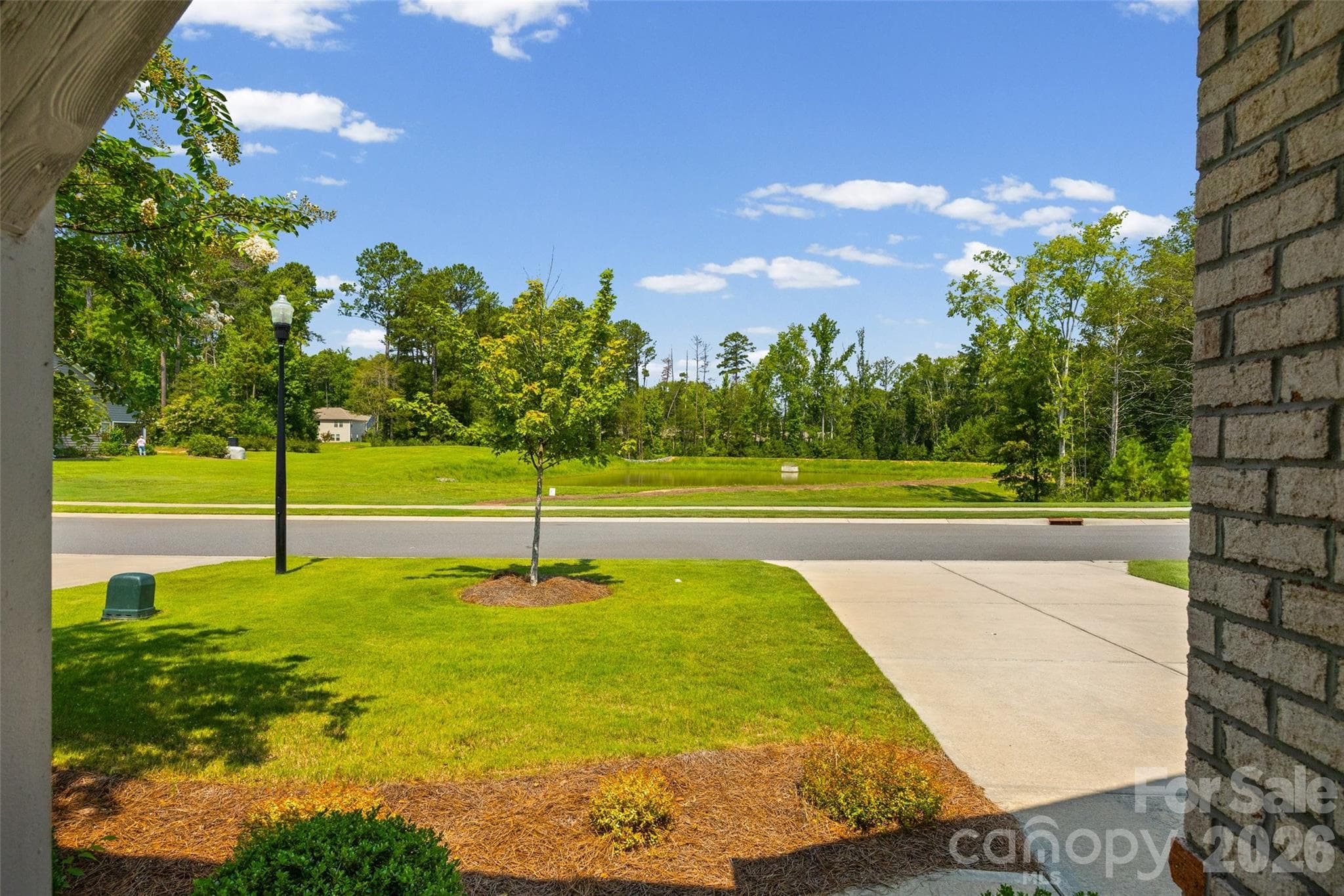 Enjoy a peaceful, wooded view and added privacy while still having all the conveniences of neighborhood living. With lawn maintenance included in the HOA, you can spend less time on yard work and more time enjoying your home. - 596 Rustlewood Way, Rock Hill