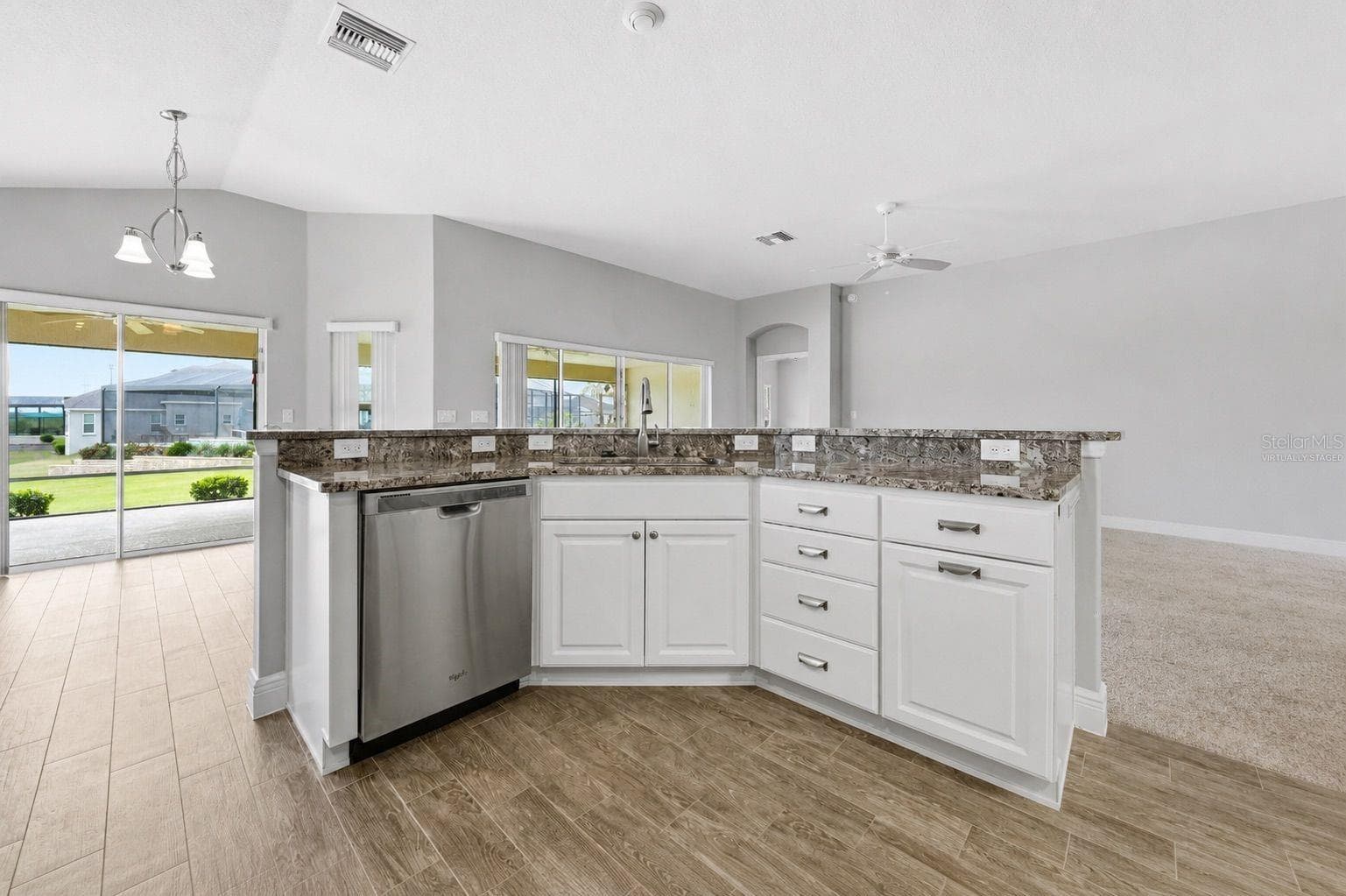 virtually staged  kitchen to dining area and lr - 1166 BLOUNT AVE, THE VILLAGES