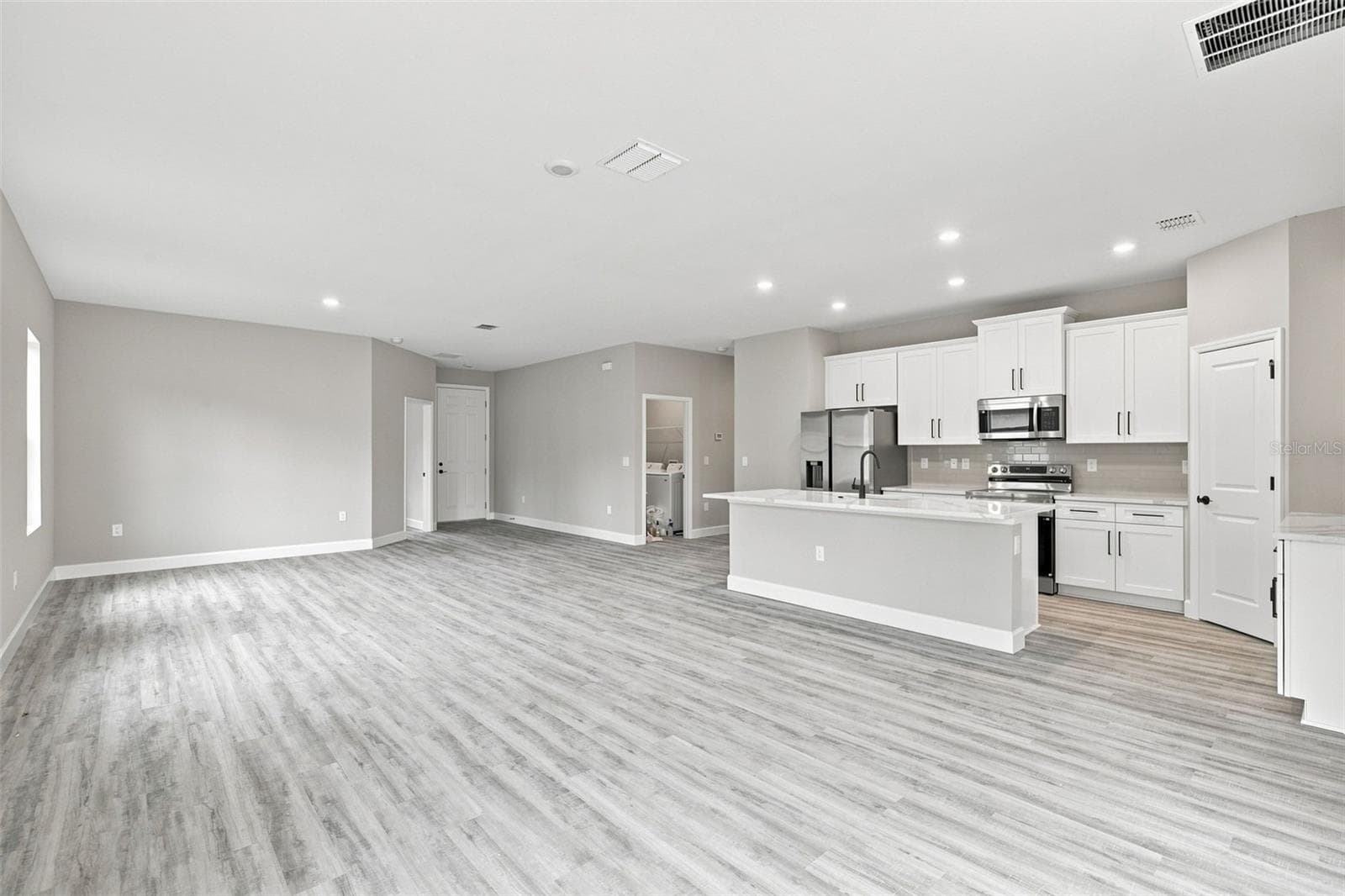 Enjoy 8' interior doors, 9' 4" high ceilings throughout, and easy care LVP flooring. - 8211 ELKENBERRY AVE, NORTH PORT