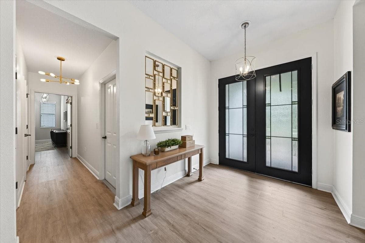 Foyer into the Guest Half Bathroom and Laundry Room - 13008 EAGLES ENTRY DR, ODESSA