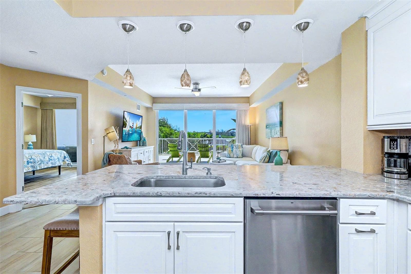... VIEW FROM KITCHEN TOWARDS MASTER SUITE THRU DOOR ON LEFT. - 19519 GULF BLVD #202, INDIAN SHORES