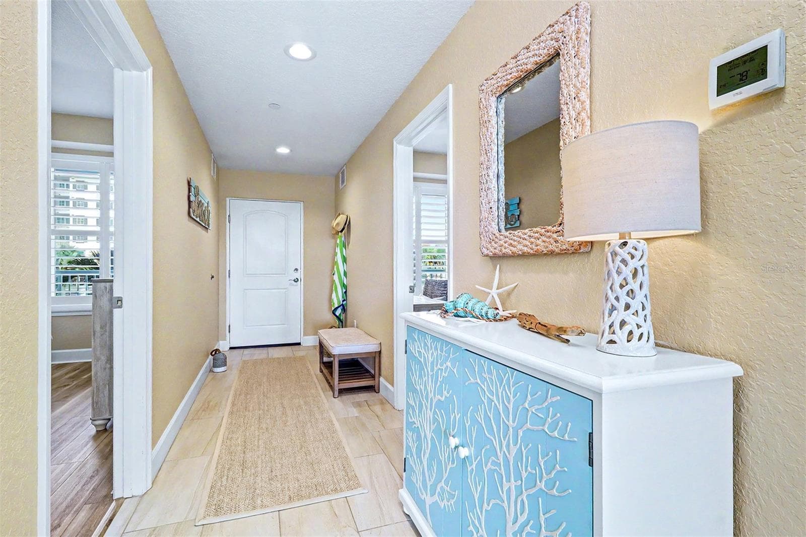 ..Entrance Door ( 2 panel solid core white ). Owners changed out the Entire Frame & installed a Fiberglass Door plus added a Storm Door with a drop down recessed Screen. Guest Bedroom on Left has Jack & Jill Door to Hall Bathroom. Guest Bedroom on Right set up as an Office / Bedroom .. - 19519 GULF BLVD #202, INDIAN SHORES