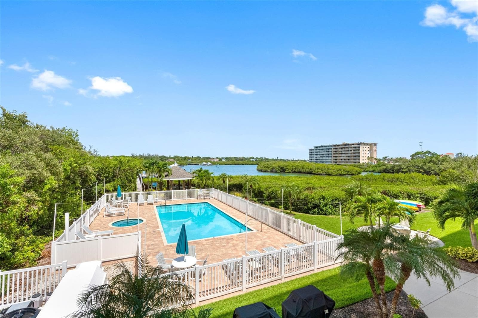 ....PHOTO OF HEATED POOL & SPA AT DOLPHIN KEY.. Kayak Storage To Right of Pool. Gazebo Behind Pool -Gas Grills at front of pool.. - 19519 GULF BLVD #202, INDIAN SHORES