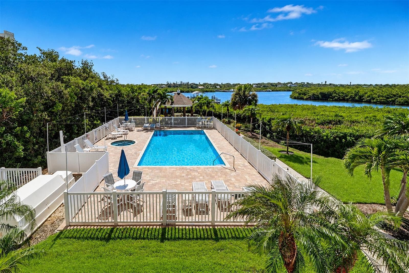 ....AMENITIES..PHOTO OF HEATED POOL & SPA AT DOLPHIN KEY.. Boat Slips , Fishing Dock Walkway behind Pool. - 19519 GULF BLVD #202, INDIAN SHORES