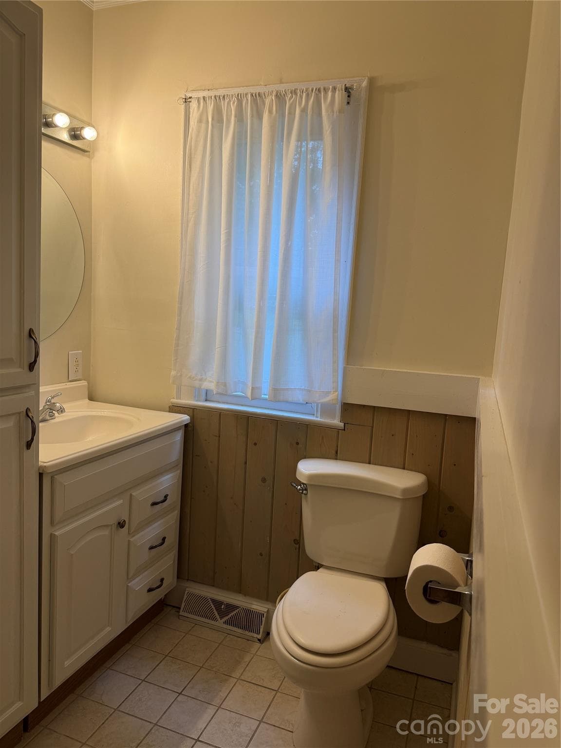 This light-filled bathroom combines everyday functionality with rustic charm, featuring, a bright window that fills the space with natural light, and attractive wood accent walls for a cozy feel - 612 Ballard Street, Chester