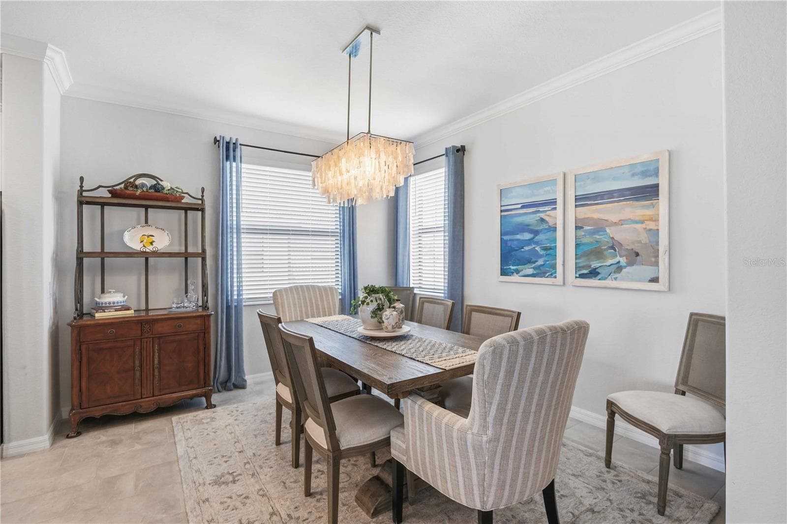 The dining room is set for six but can easily be set for more. - 10821 TARFLOWER DR #202, VENICE