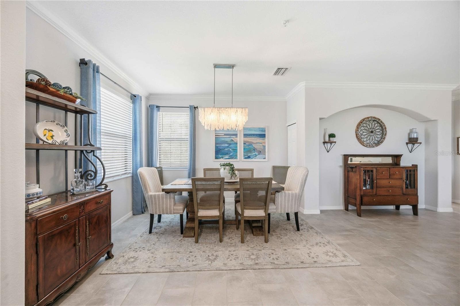 The dining room is set for six but can easily be set for more. - 10821 TARFLOWER DR #202, VENICE