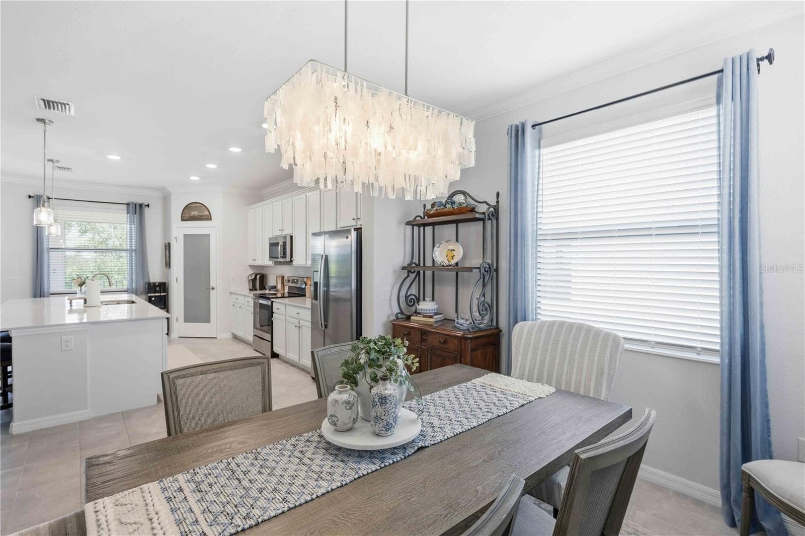 The dining room is set for six but can easily be set for more. - 10821 TARFLOWER DR #202, VENICE