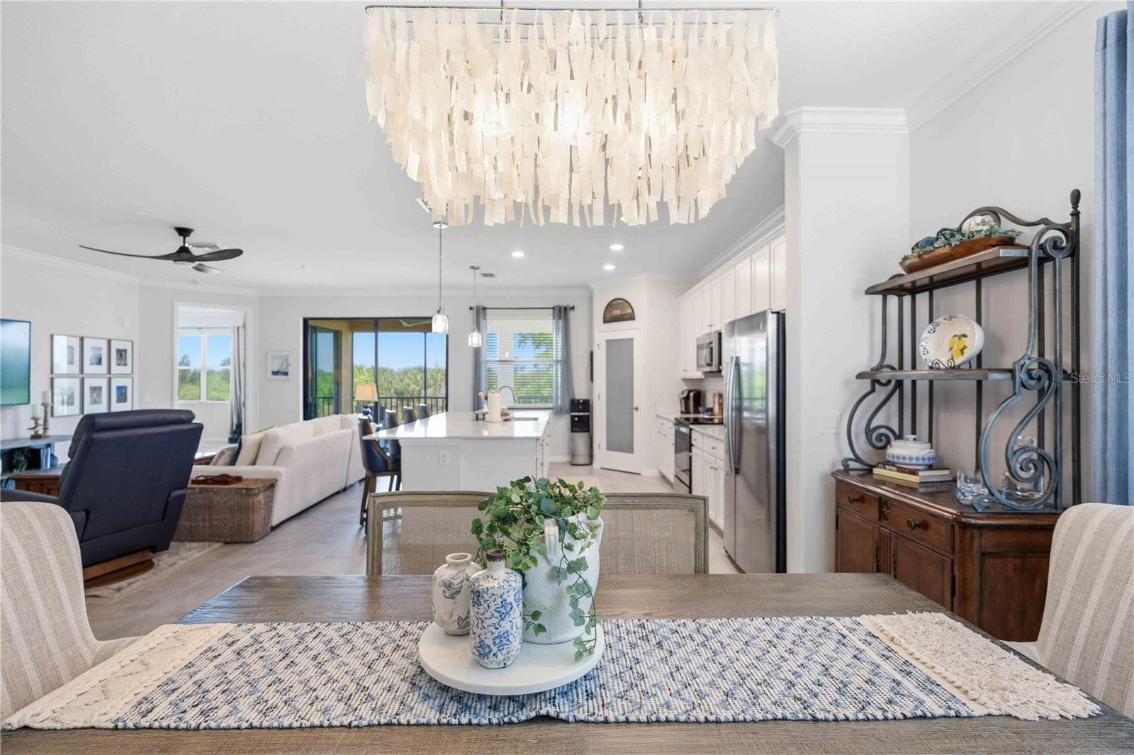 The dining room is set for six but can easily be set for more. - 10821 TARFLOWER DR #202, VENICE
