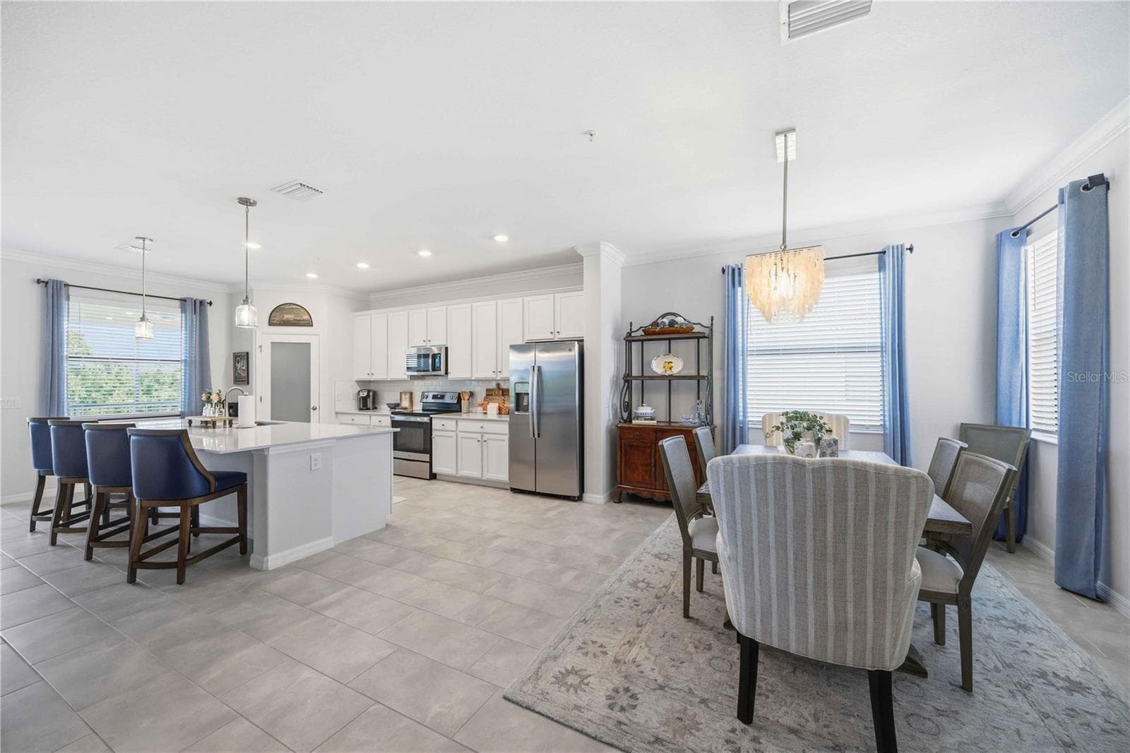 The dining room is set for six but can easily be set for more. - 10821 TARFLOWER DR #202, VENICE