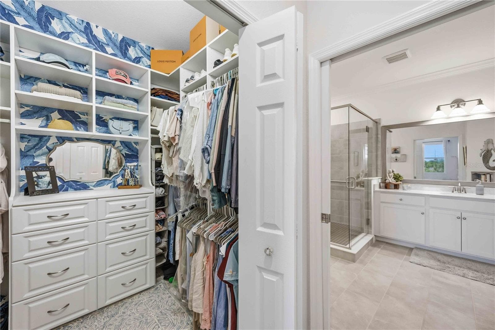 The master closet is totally organized - 10821 TARFLOWER DR #202, VENICE