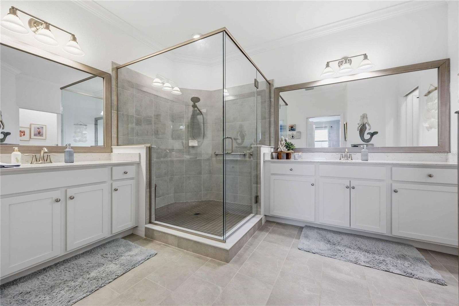 The ensuite bath has a huge shower and dual vanities /sinks and a private water closet. - 10821 TARFLOWER DR #202, VENICE