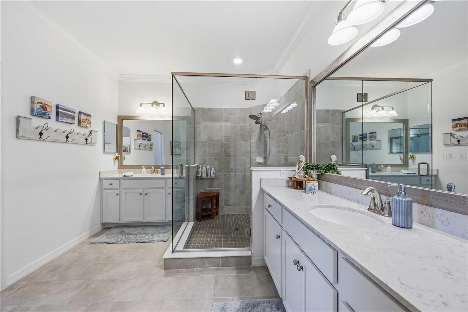 The ensuite bath has a huge shower and dual vanities /sinks and a private water closet. - 10821 TARFLOWER DR #202, VENICE