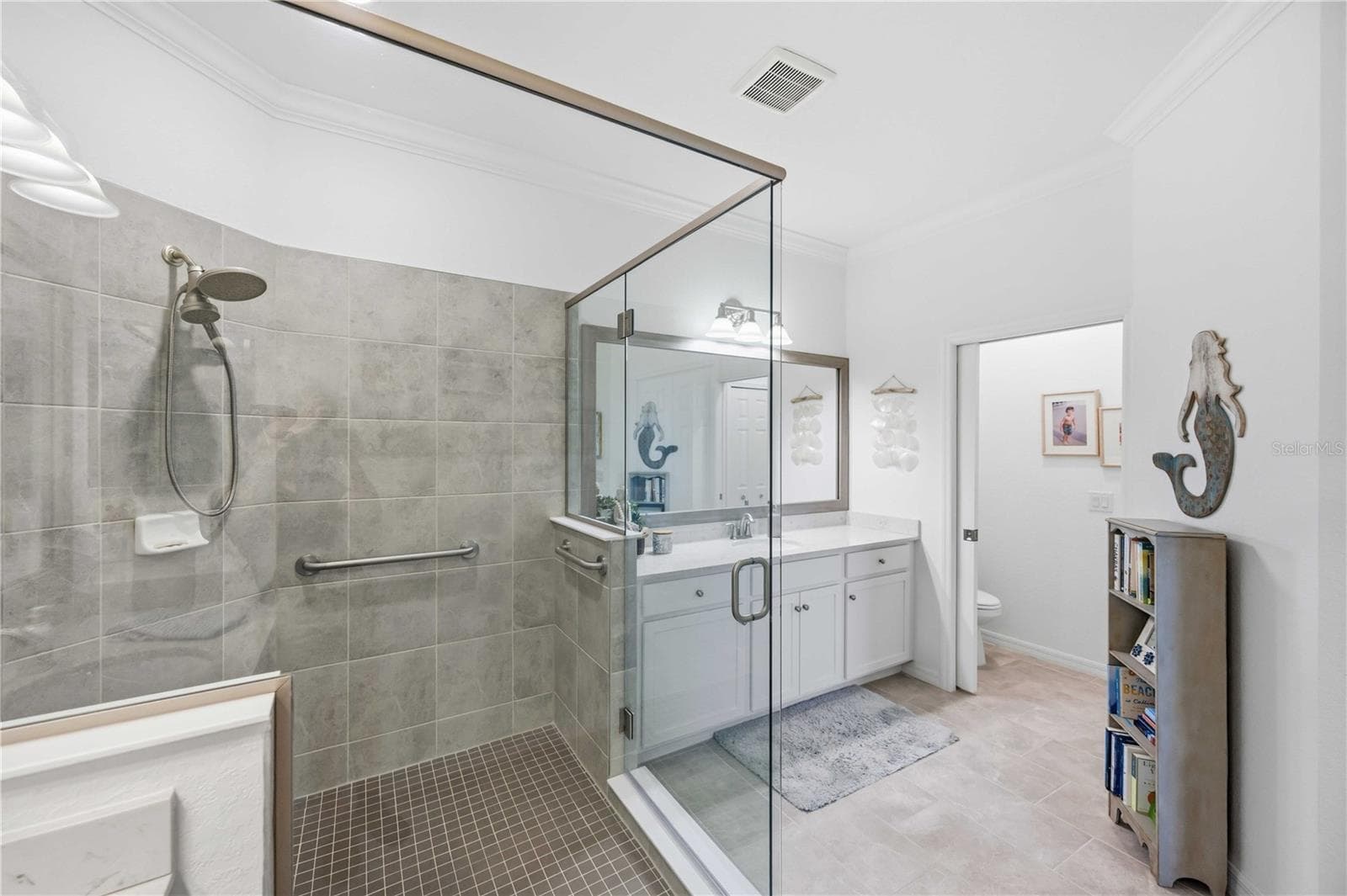 The ensuite bath has a huge shower and dual vanities /sinks and a private water closet. - 10821 TARFLOWER DR #202, VENICE