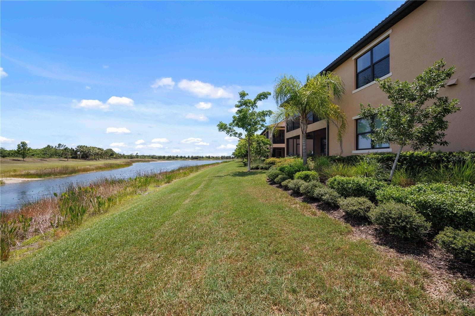 The condo has a large back yard that sits by the lakeshore - stunning water views - 10821 TARFLOWER DR #202, VENICE