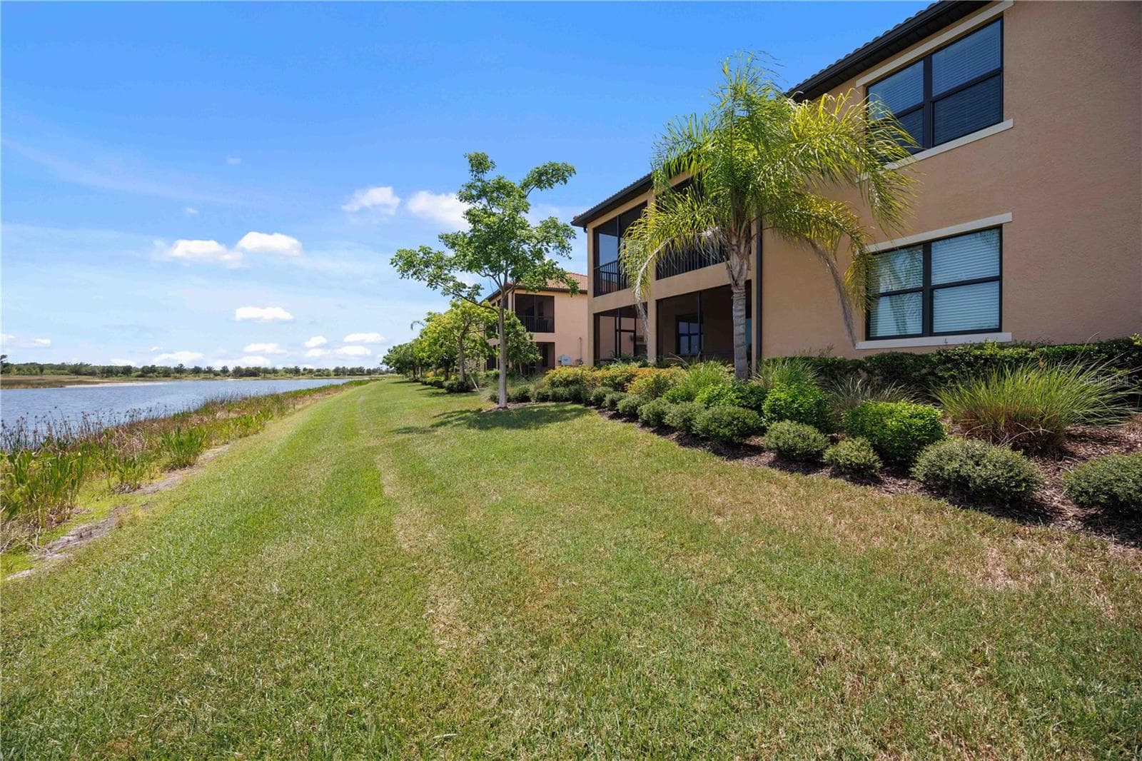 The condo has a large back yard that sits by the lakeshore - stunning water views - 10821 TARFLOWER DR #202, VENICE
