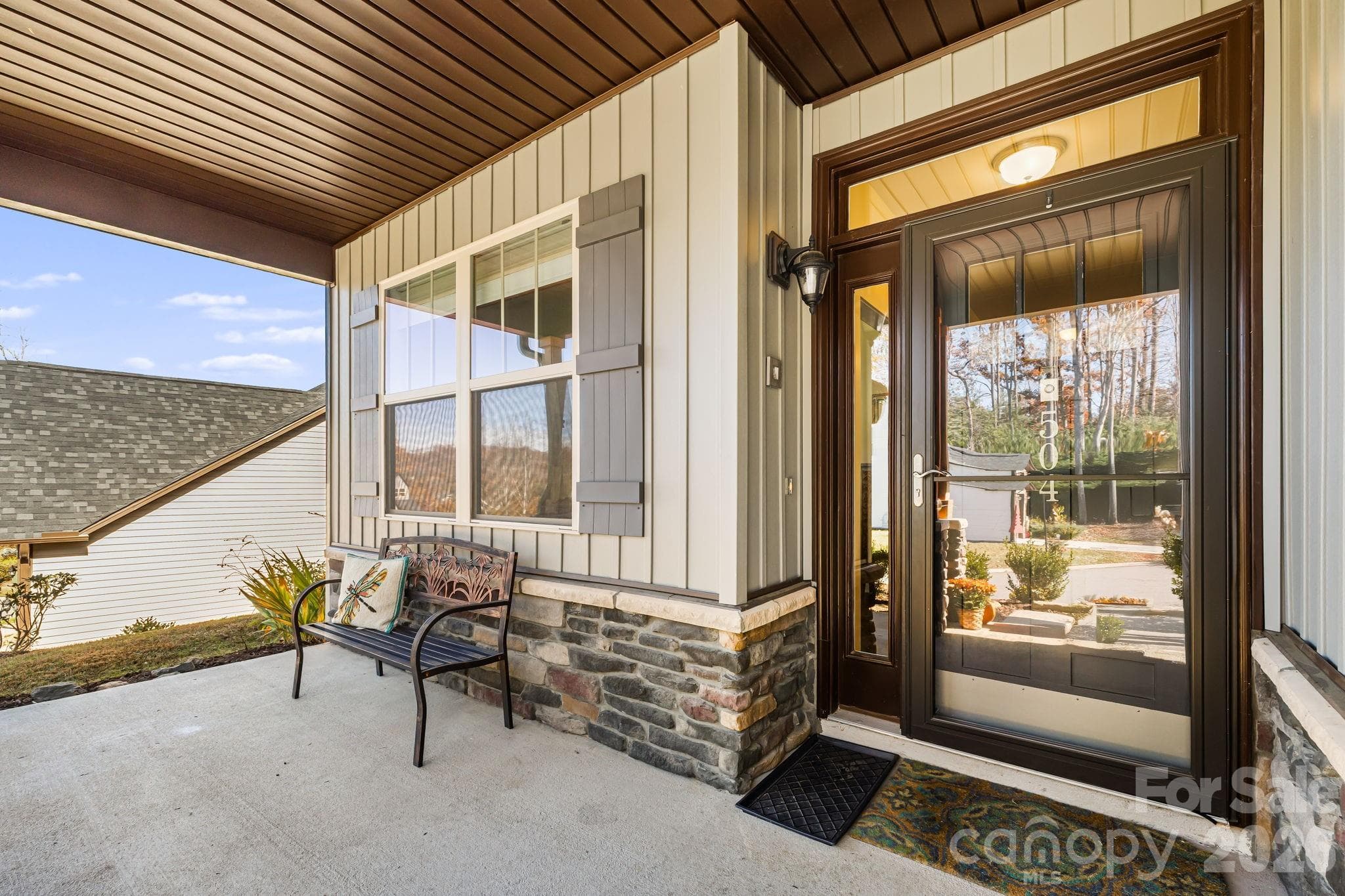 Front Porch with Stone accents and a glass door in front of the main door - Weaverville