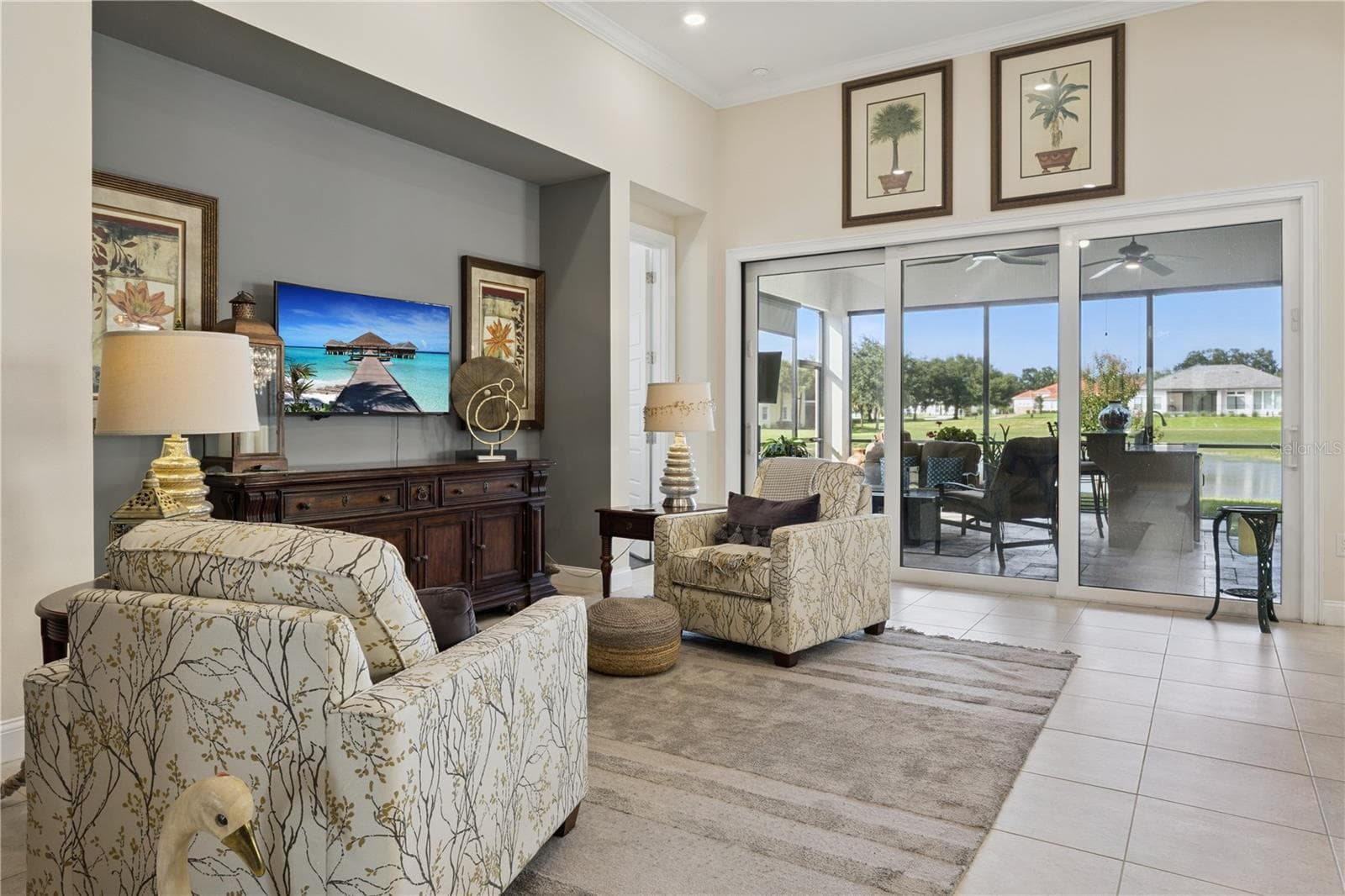 Open living room with sliding doors to Summer Kitchen - 9219 SAN JOSE BLVD, HOWEY IN THE HILLS