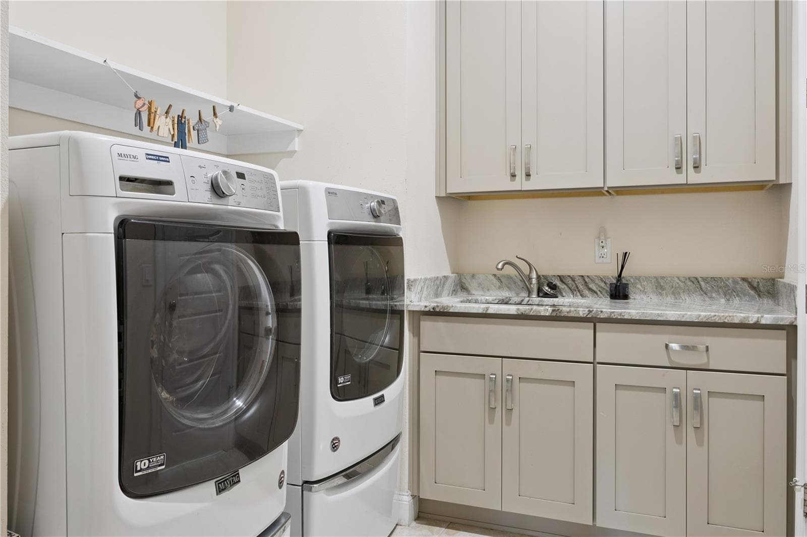 Laundry with sink, custom, cabinets, granite countertops, washer & dryer. - 9219 SAN JOSE BLVD, HOWEY IN THE HILLS