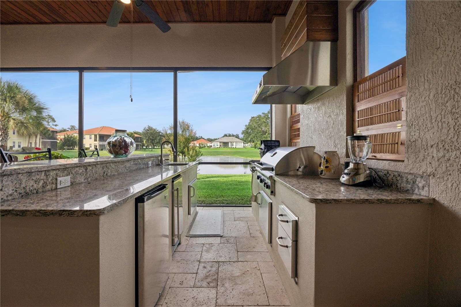 Sink, gas grill & small refrigerator. Beautiful view of the pond. - 9219 SAN JOSE BLVD, HOWEY IN THE HILLS