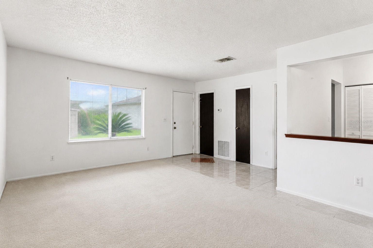 Virtually staged living room and entry - 1418 CATALINA BLVD, DELTONA