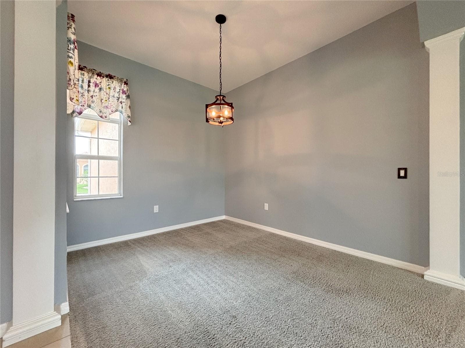 Formal Dining Area with Window and Accent Columns - 1124 SAWGRASS DR, WINTER HAVEN