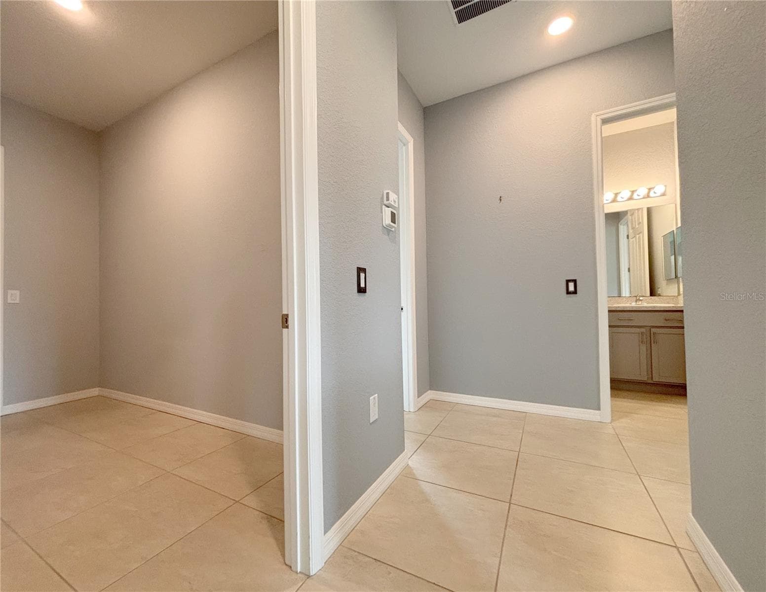 Hallway to Laundry Room, Bed 2 & 3 and Guest Bath - 1124 SAWGRASS DR, WINTER HAVEN