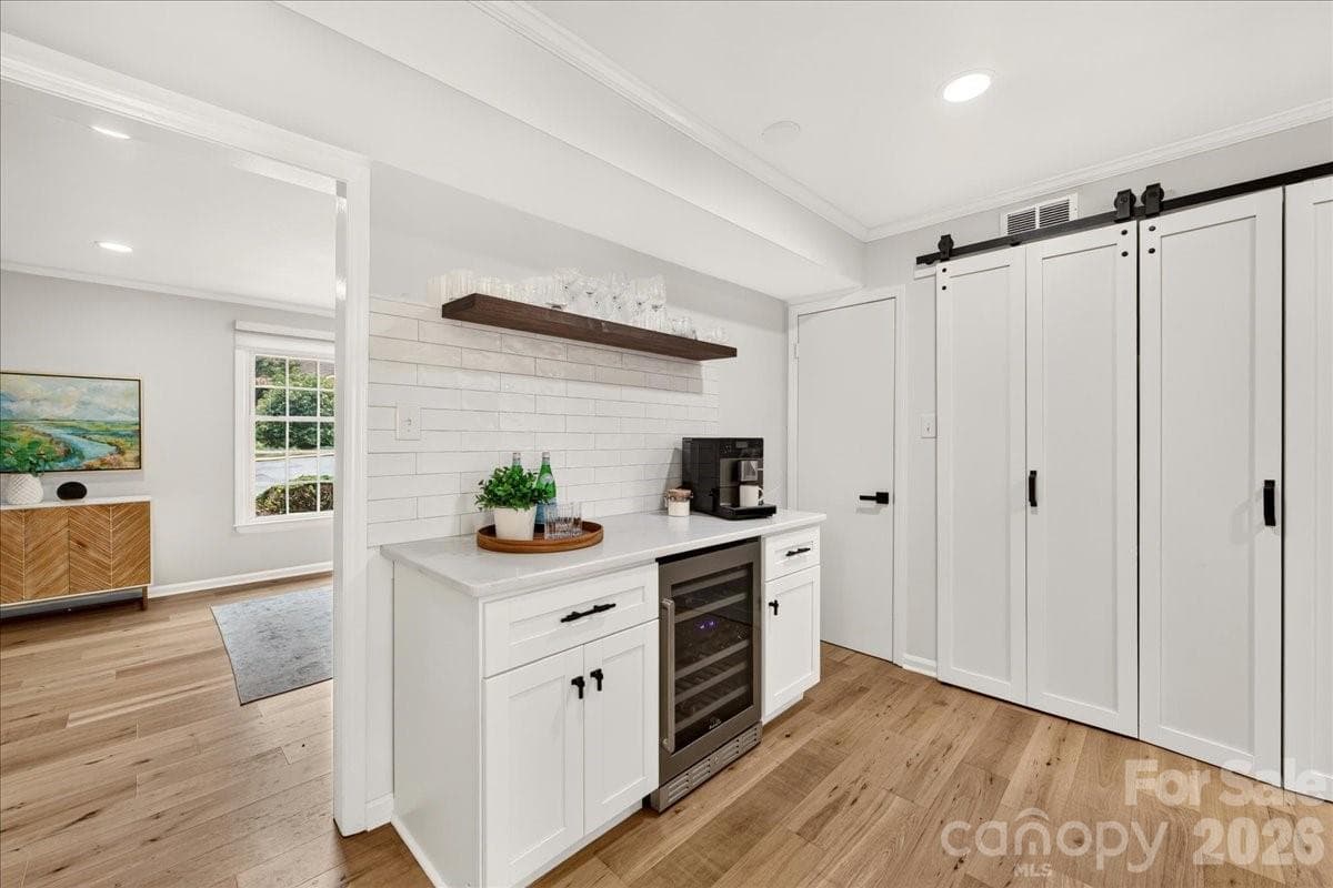 The kitchen features a beverage station with bev fridge and additional cabinetry- perfect spot for coffee or to set up your bar - 3500 Colony Road, Charlotte