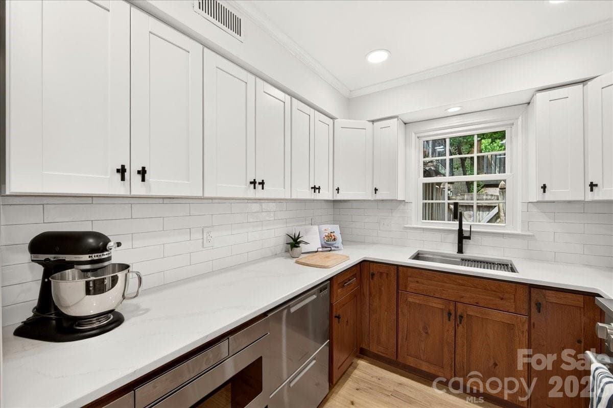 Two toned cabinets, quartz counters, double dishwasher drawers, low profile microwave are just some of the features of this gorgeous kitchen - 3500 Colony Road, Charlotte