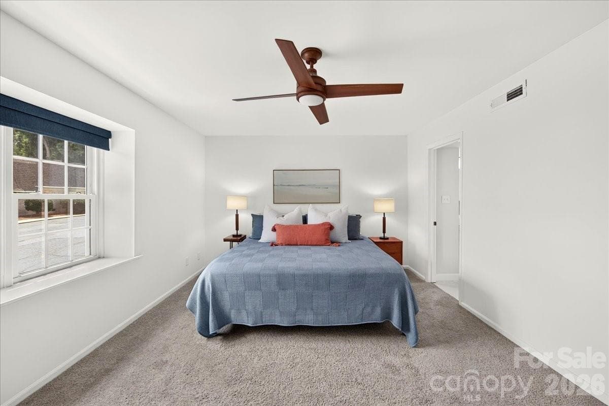 Perfectly sized primary bedroom with two closets and remote control window shade - 3500 Colony Road, Charlotte