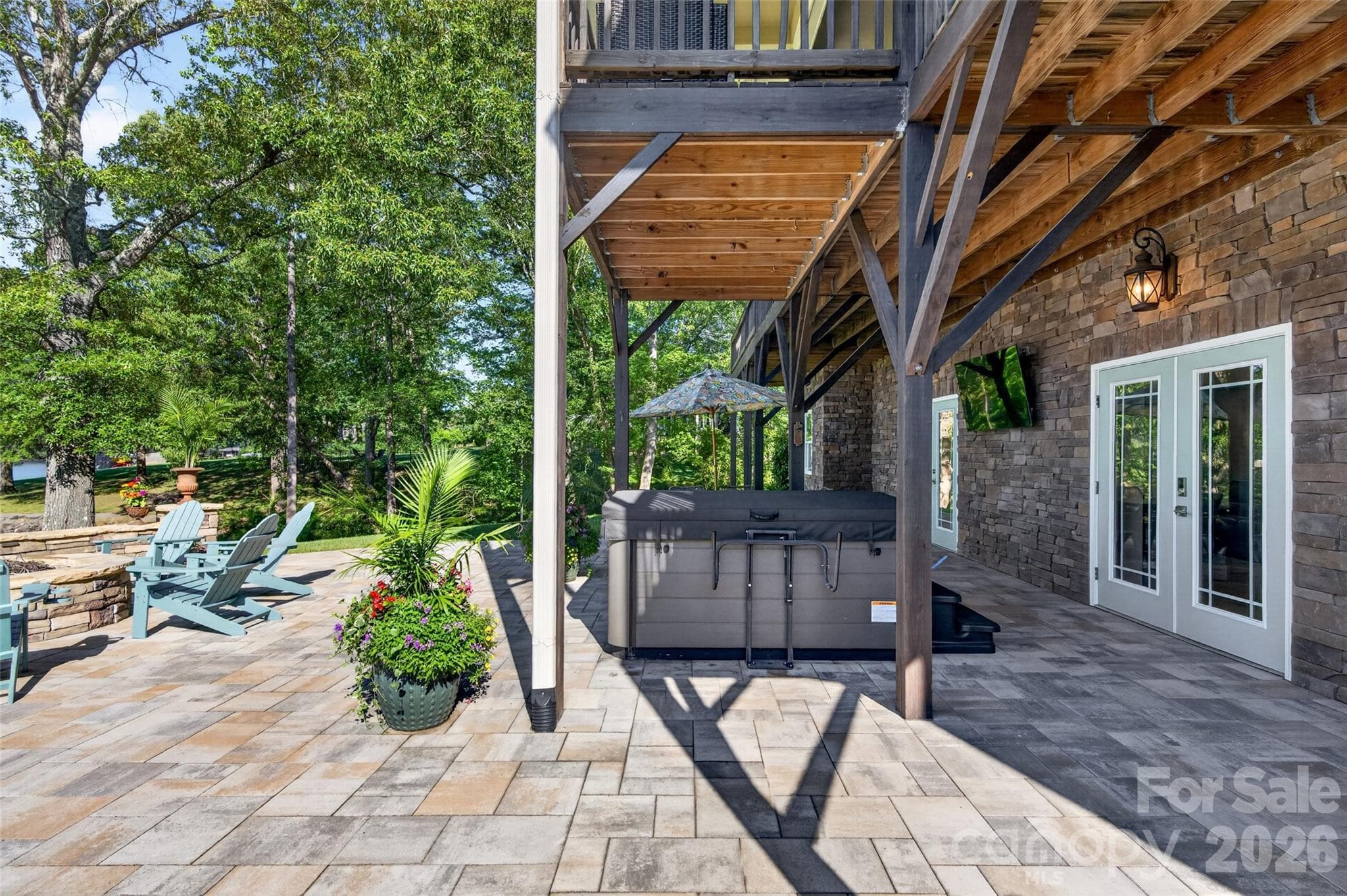 Stone Patio Lower Level with Hot Tub and Fire Pit - 7144 Lynbrook Creek Road, Denver