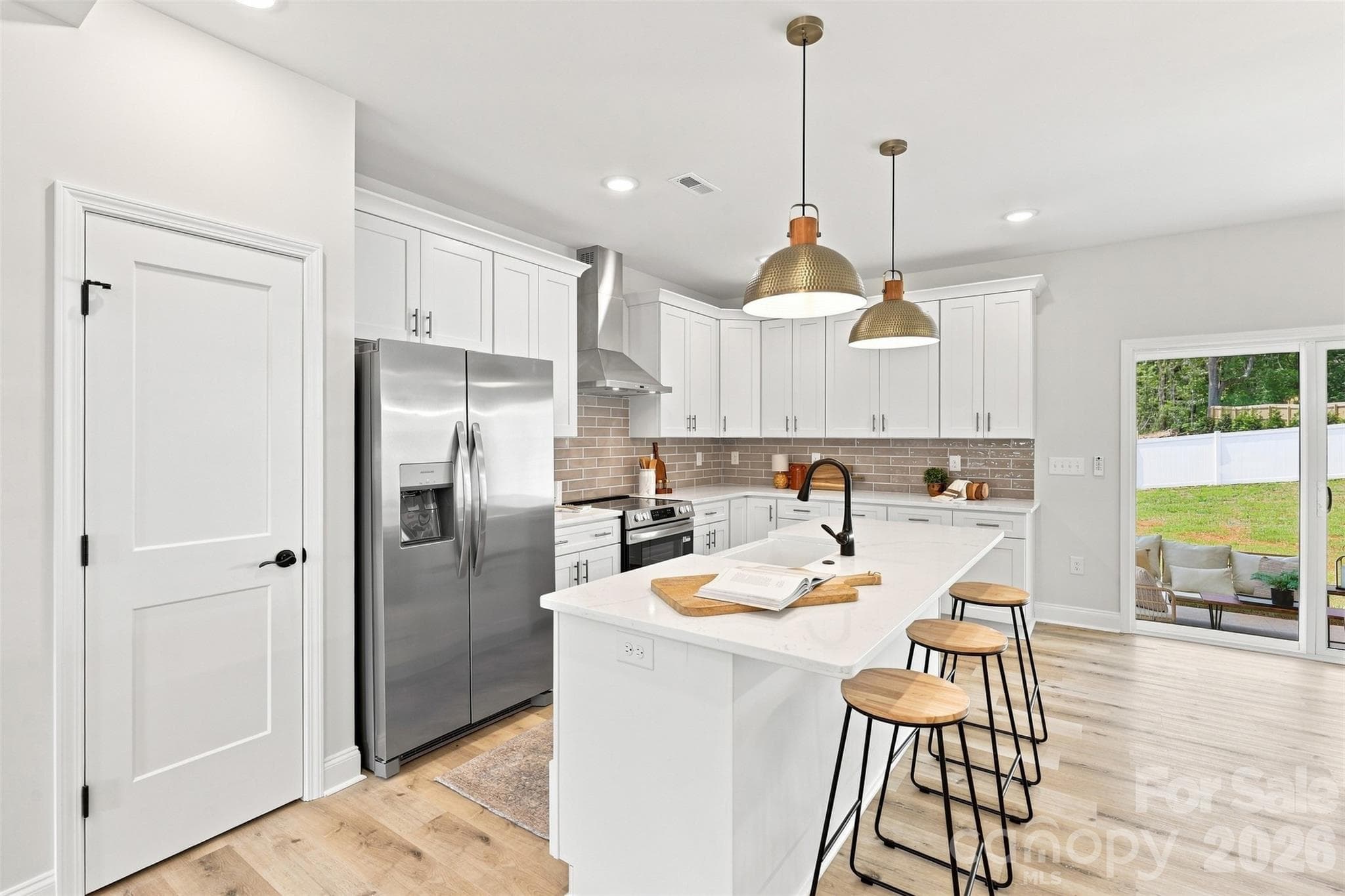 kitchen w/ thoughtfully updated cabinets & countertops, porcelain farmhouse sink, stainless steel hood vent - 390 NC 200 Highway S, Stanfield