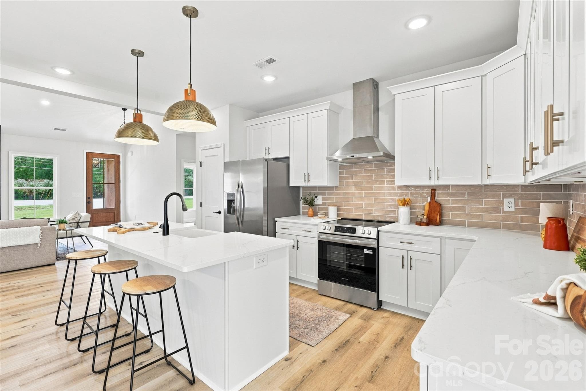 kitchen w/ thoughtfully updated cabinets & countertops, porcelain farmhouse sink, stainless steel hood vent - 390 NC 200 Highway S, Stanfield