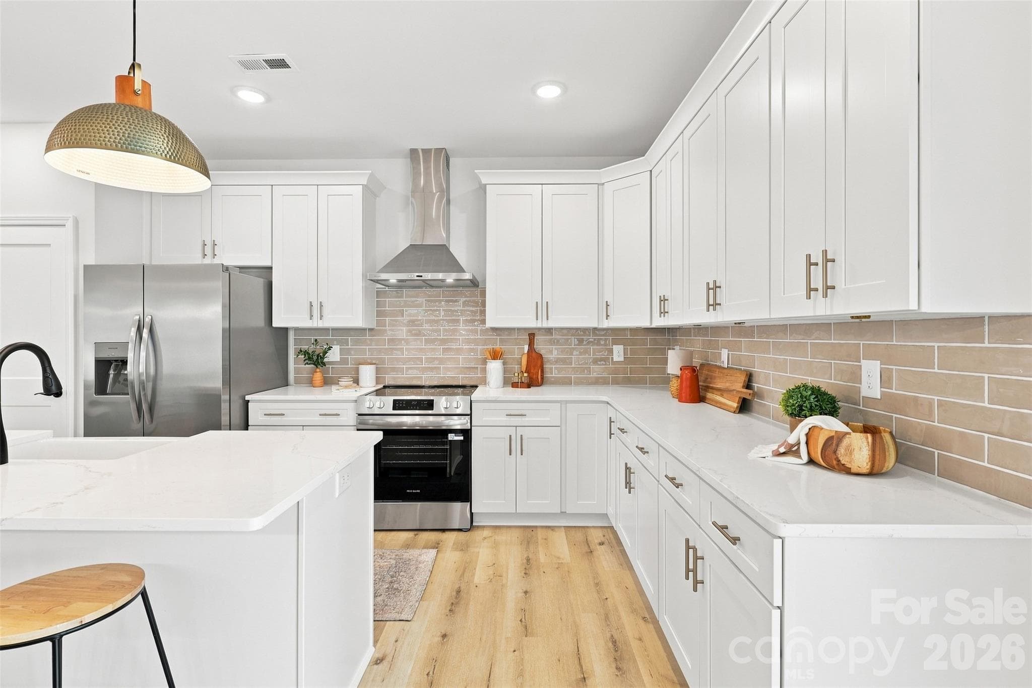 kitchen w/ thoughtfully updated cabinets & countertops, porcelain farmhouse sink, stainless steel hood vent - 390 NC 200 Highway S, Stanfield