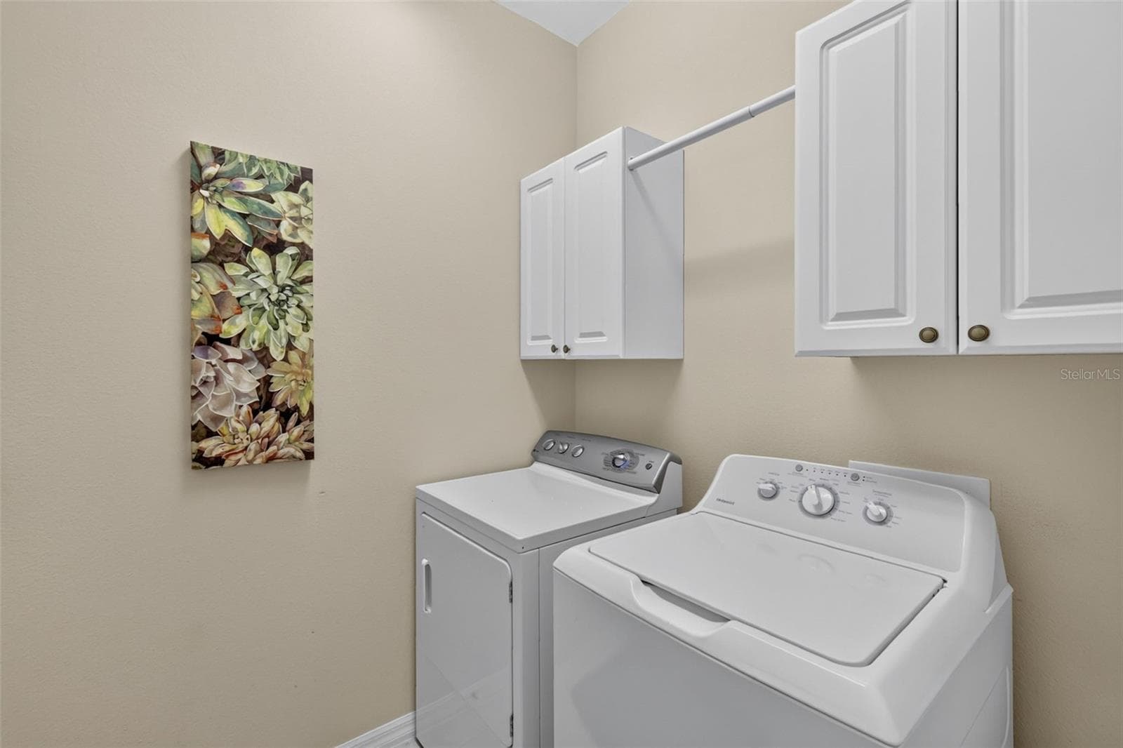 Laundry room with set sink and extra cabinets for storage. - 2693 IRIS WAY, THE VILLAGES