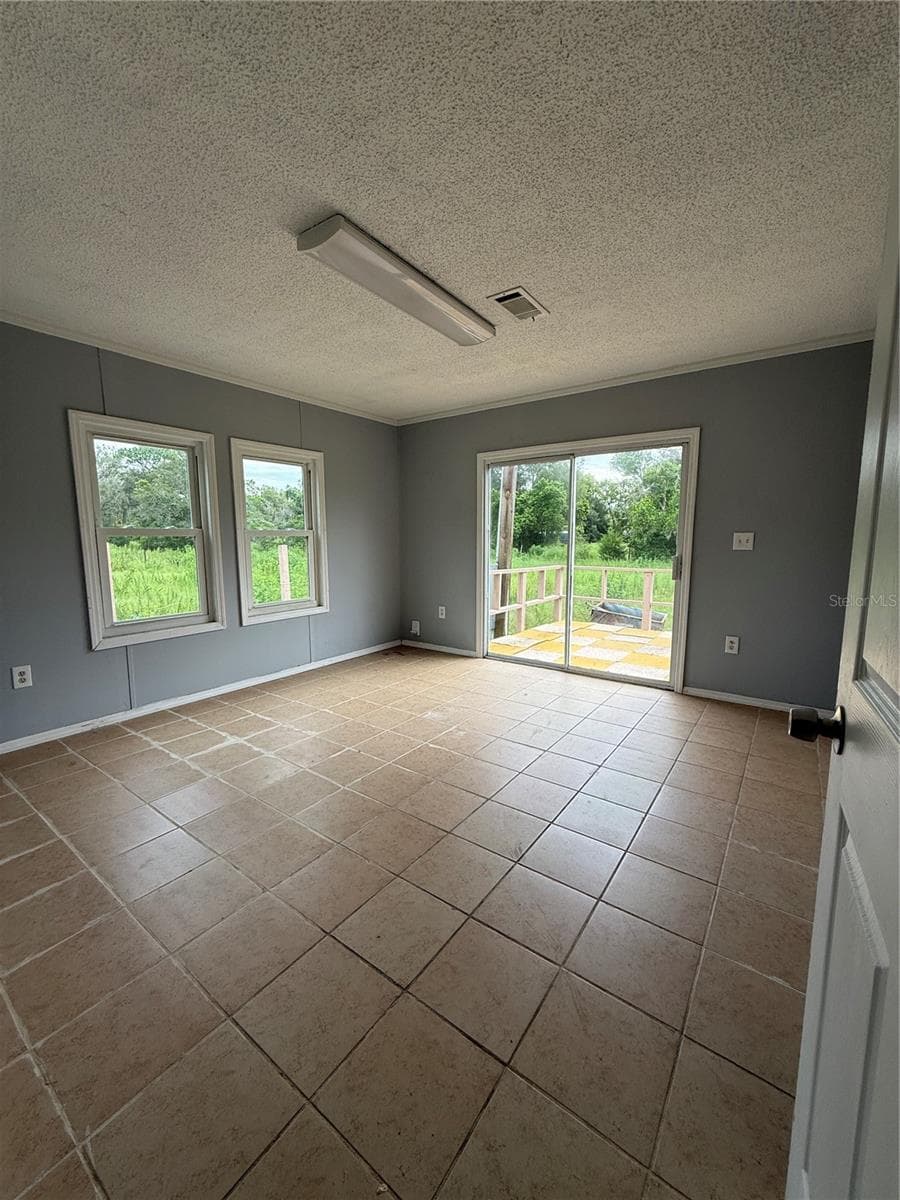 Primary bedroom with slider and deck - 16036 BOSLEY DR, SPRING HILL