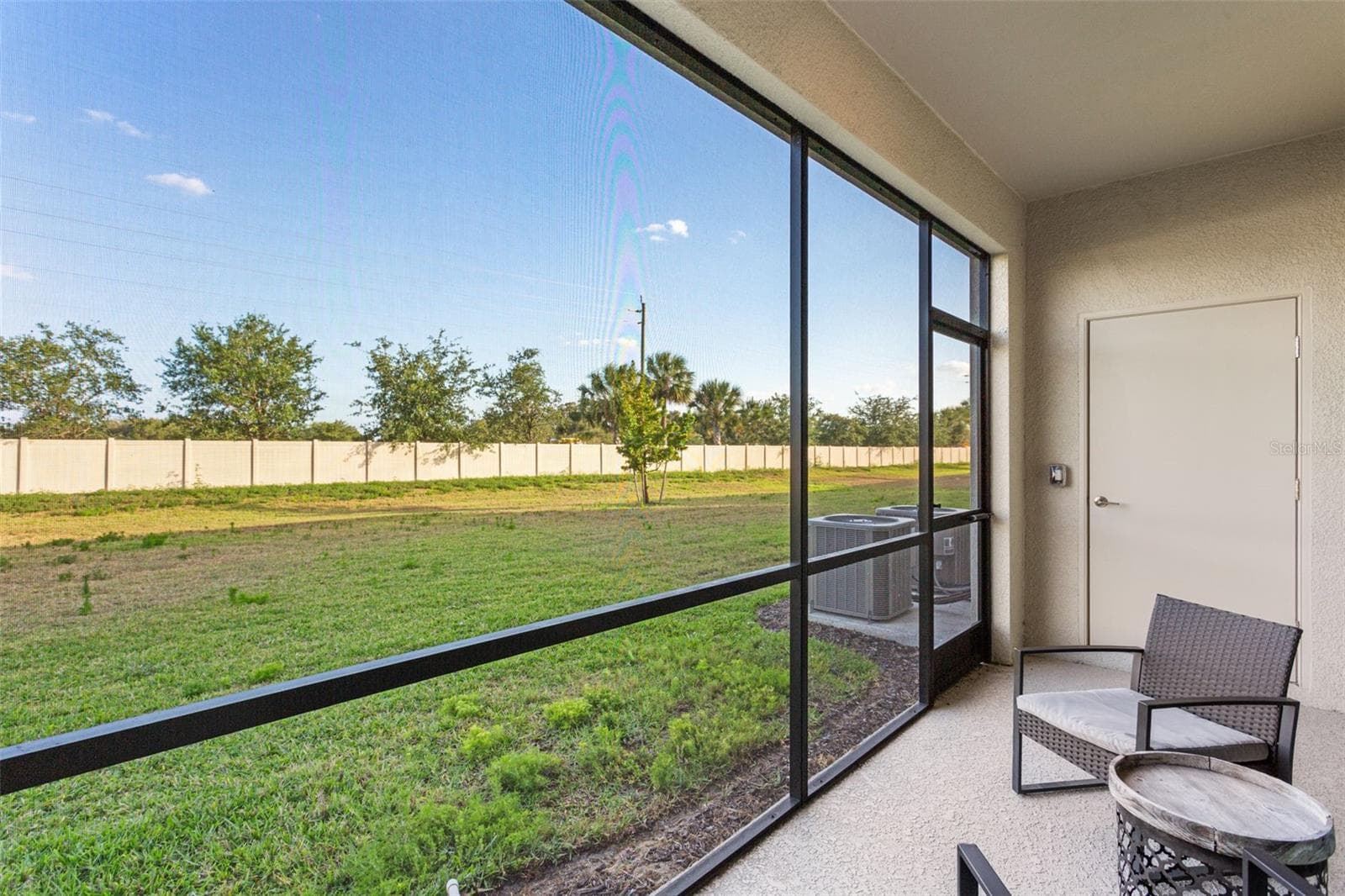 The southeast-facing screened lanai provides serene sunrise views and extra outdoor storage, all overlooking beautifully landscaped green space - 14275 PINE LODGE LN, FORT MYERS
