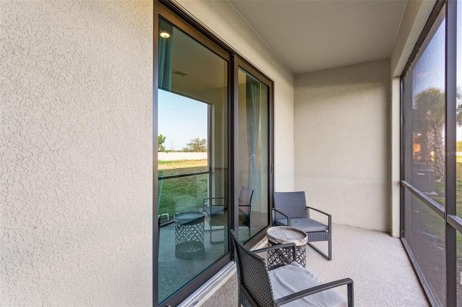 Private screened lanai overlooking the peaceful green space, complete with a convenient outdoor storage room - 14275 PINE LODGE LN, FORT MYERS