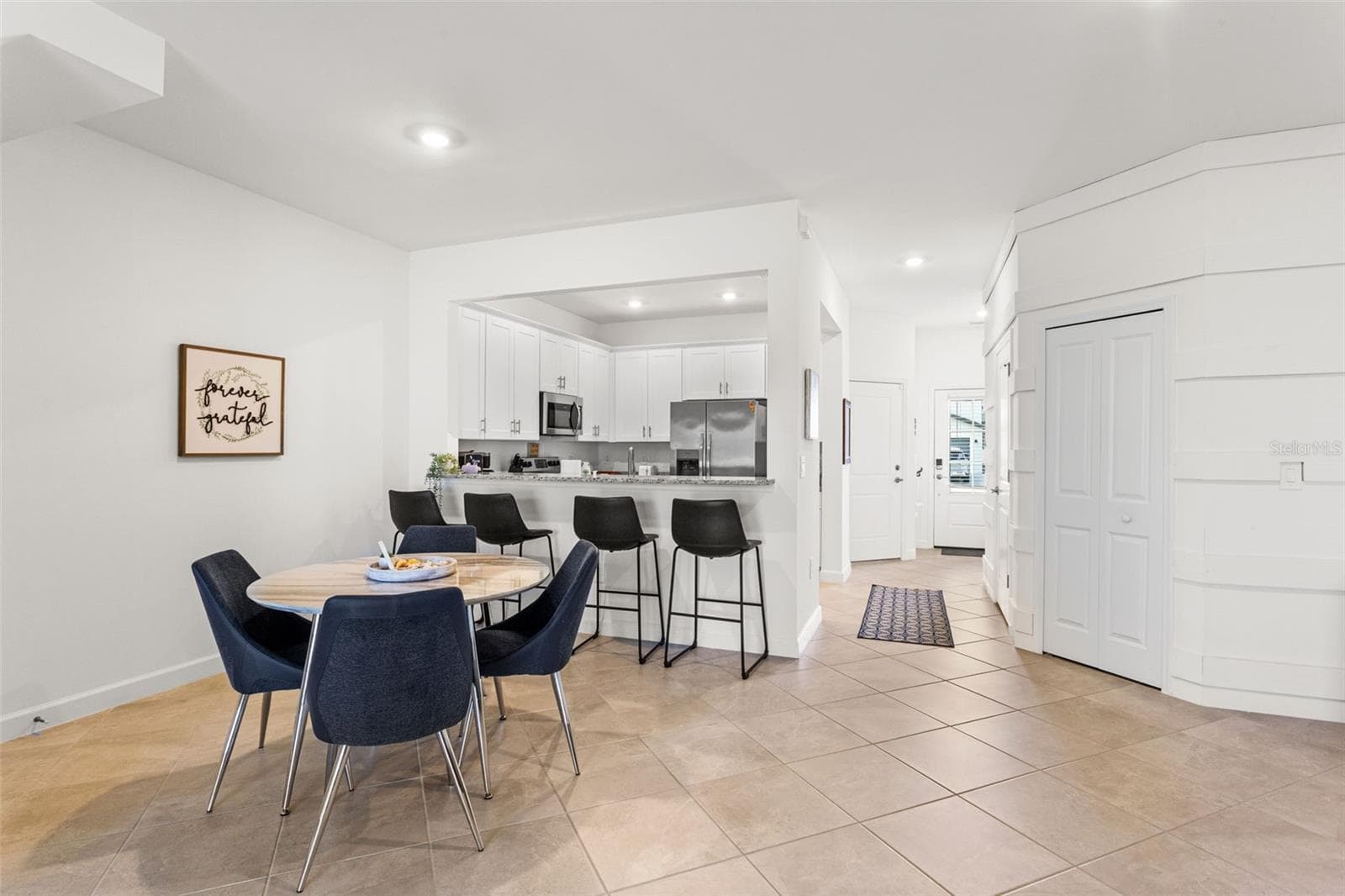 The adjoining living and dining areas are open, airy, and perfect for both relaxing and entertaining - 14275 PINE LODGE LN, FORT MYERS