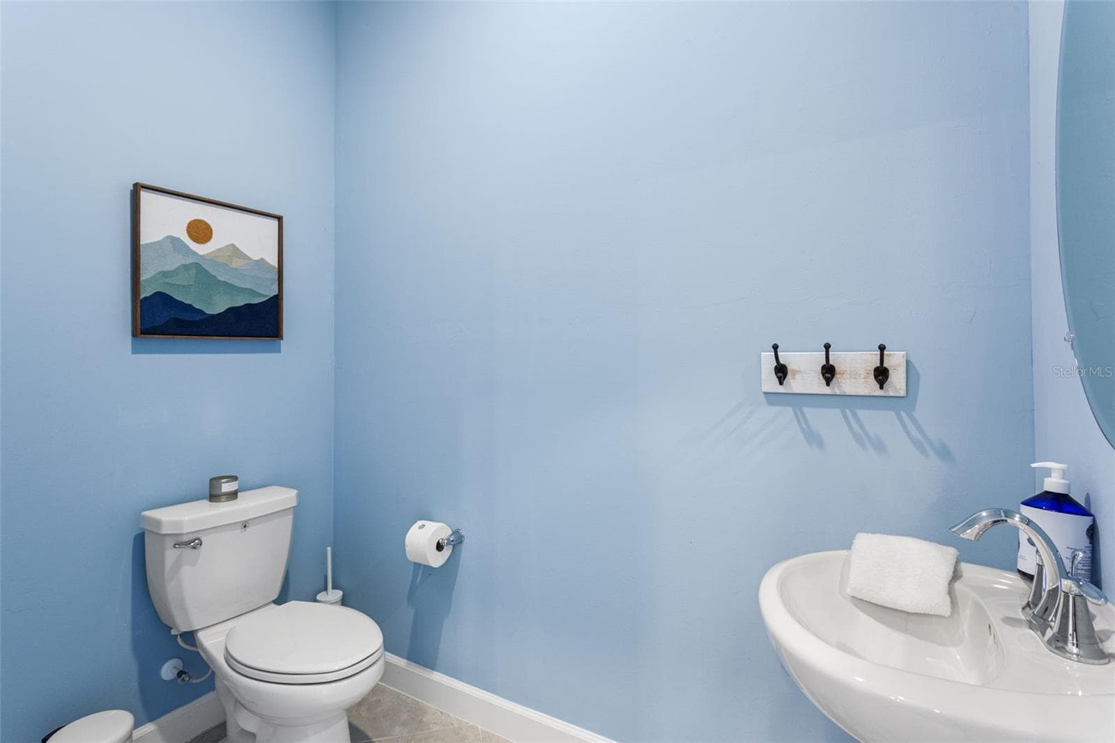 Convenient half bathroom located near the main entrance, perfect for guests - 14275 PINE LODGE LN, FORT MYERS