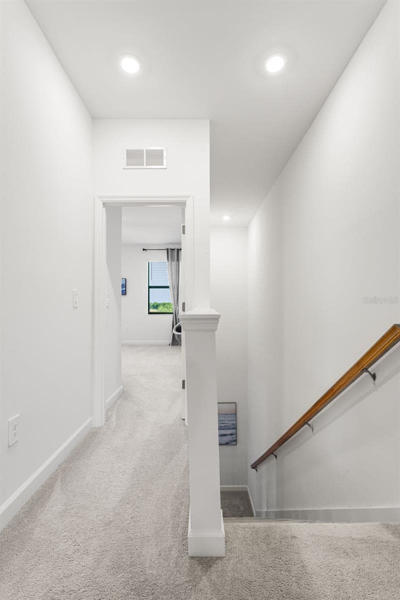 Bright upstairs hallway with recessed lighting, connecting the bedrooms and living spaces with ease - 14275 PINE LODGE LN, FORT MYERS